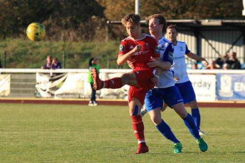Whitehawks Fintan Walsh (red )clears from Aaron Greene