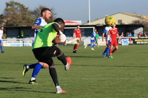 Whitehawks Melvin Minter clears as Billy Bricknell challenges