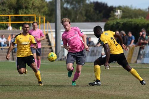 Enfields Aaron Greene and Folkestones Kieron McCann (L) and Jerald Aboagye