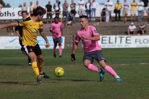 Enfields Brandon Adams (R) takes the ball past Matt Newman before scoring the first of his two goals