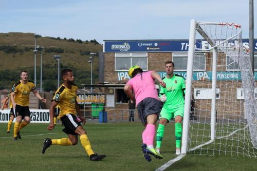 Enfields Lewis Taaffe heads the ball back into the Folkestone goal area
