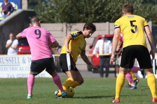 Enfields Liam Hope (9) challenges Matt Newman