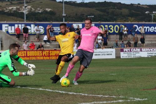 Enfields Liam Hope (R) tries to take the ball round Nat Blanks and keeper Tim Roberts
