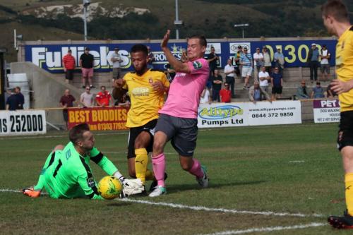 Enfields Liam Hope (R) tries to take the ball round Nat Blanks and keeper Tim Robertsx