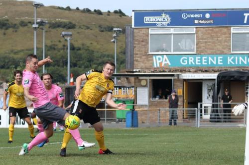 Enfields Liam Hope (pink) stretches for a loose ball