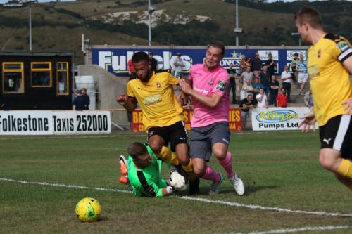 Enfields Liam Hope (pink) tries to take the ball round Nat Blanks and keeper Tim Roberts