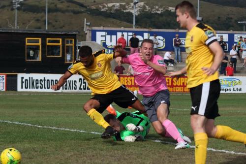 Enfields Liam Hope (pink) tries to take the ball round Nat Blanks and keeper Tim Robertsx
