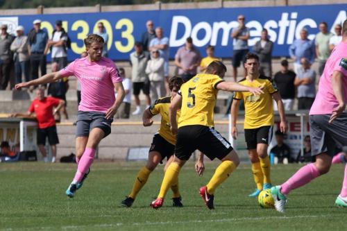 Enfields Remi Sutton (L) tries to thread a pass through to Liam Hope
