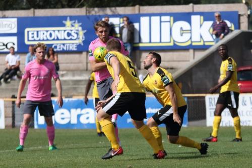 Enfields Remi Sutton (pink) tries to keep the ball in the Folkestone box