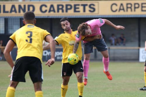 Enfields Sam Chaney (R) challenges Kieron McCann