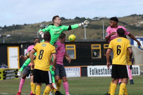 Folkestone keeper Tim Roberts misses a punch
