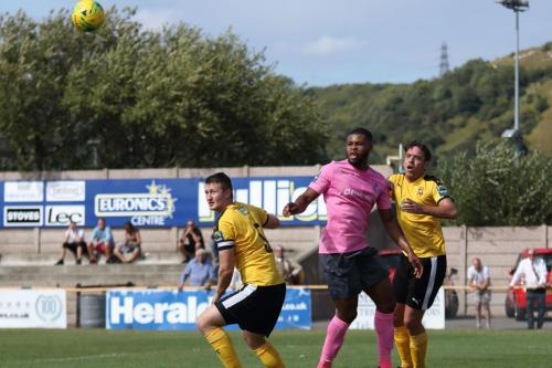 Folkestones Callum Davies (L) and Jack Evans and Enfields Taofiq Olomowewe