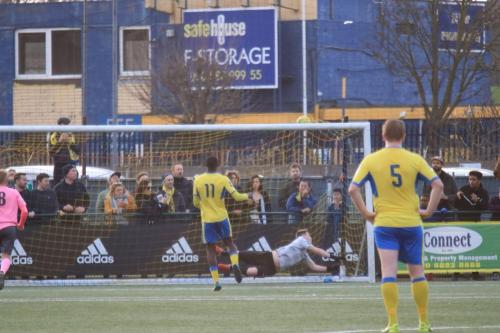 Enfield keeper Matt Nolan gets a hand to Joel Noubles penalty but can only deflect it into the roof of the net