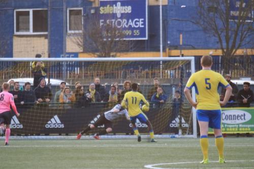 Enfield keeper Matt Nolan gets a hand to Joel Noubles penalty but can only deflect it into the roof of the netx