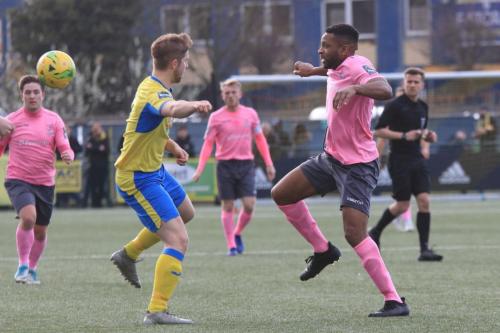 Enfields Kezie Ibe (R) and Haringeys Scott Mitchell