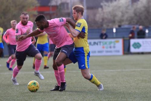 Enfields Kezie Ibe holds off Scott Mitchell (yellow)