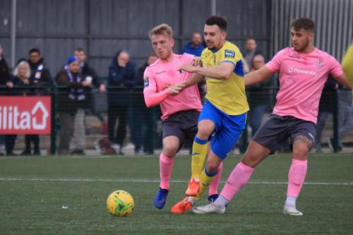 Enfields Ryan Blackman (L) and Dan Rumens challenge Lyle Della Verde