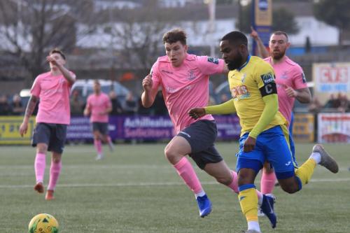 Haringey captain David Olufemi (yellow) challenges Josh Davison who has been flagged offside