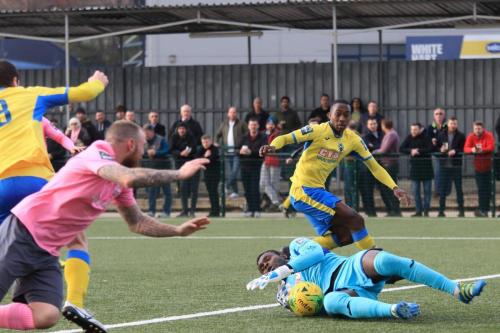 Haringey keeper Valery Pajetat cuts out a cross from the Enfield right