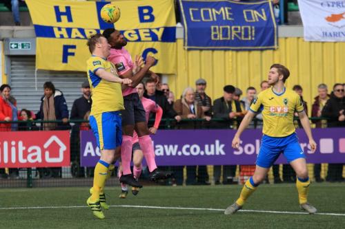 Haringeys Mark Kirby (L) challenges Kezie Ibe, watched by Scott Mitchell