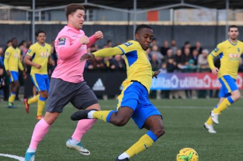 Haringeys Rakim Richards (yellow) clears from Lewis Taaffe