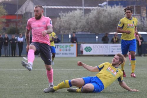 Haringeys Scott Mitchell (yellow) tackles Billy Bricknell