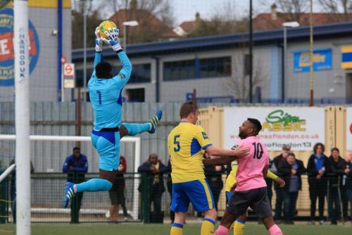Haringeys Valery Pajetat collects a cross as Mark Kirby (5) keeps Kezie Ibe at bay