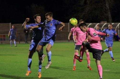 Enfields Brandon Adams (R) heads on goal