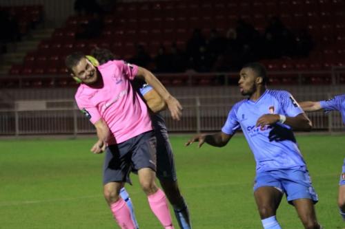 Enfields Liam Hope (pink) cant quite ghet his head to the ball