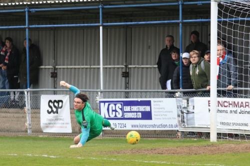 Enfield keeper Joe Wright watches an early shot fly wide
