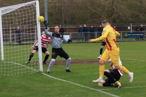 Enfields Billy Bricknell (yellow) sees his shot deflected onto the post