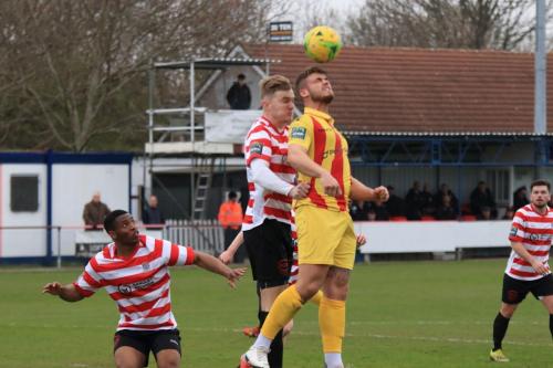 Enfields Dan Rumens (yellow) challenges James Richmond