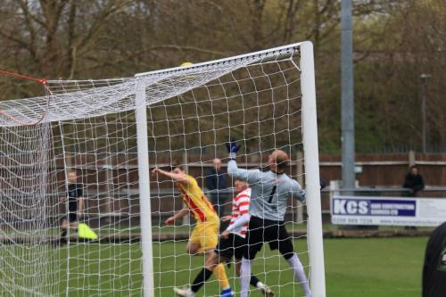 Enfields Josh Davison (yellow) heads narrowly over