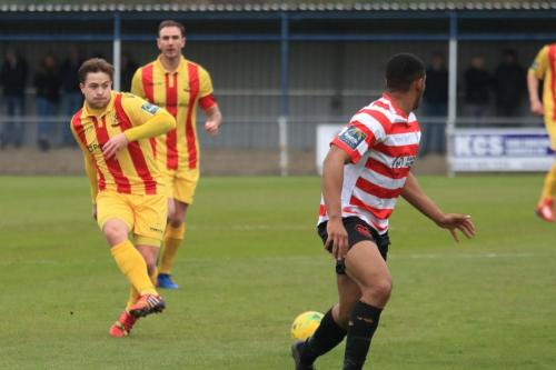 Enfields Lewis Taaffe (L) and Matt Johnson and Kingstonians Jonathan Muleba