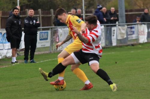 Enfields Sam Chaney (yellow) and Kingstonians Aaron Lamont