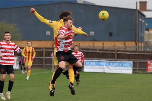 Enfields Sam Youngs (yellow) challenges Tom Bird