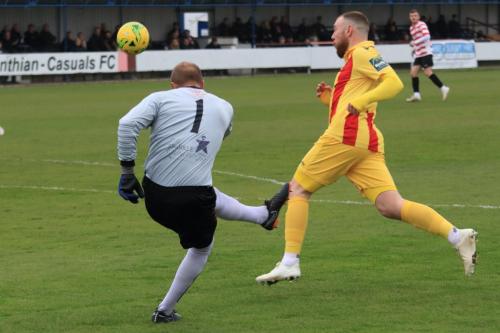Kingstonian keeper Rob Tolfrey clears from Billy Bricknell