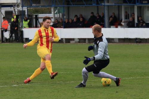 Kingstonian keeper Rob Tolfrey just manages to save Lewis Taaffes shot with his right foot