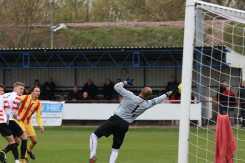 Kingstonian keeper Rob Tolfrey tips the ball round the post