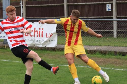 Kingstonians Alfie Egan (L) tries to block a cross by Dan Rumens