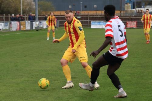 Kingstonians Ismail Yakubu (R) clears from Billy Bricknell