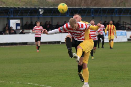 Kingstonians James Richmond (L) clears from Billy Bricknell