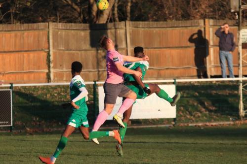 Enfields Dan Rumens (pink) challenges Shaun Okojie
