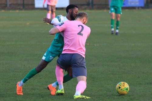 Enfields Sam Hatton (R) holds off DSean Theobalds
