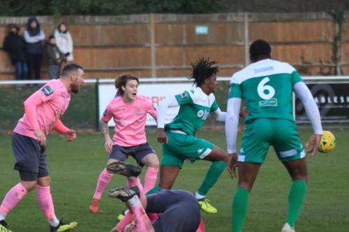 Leatherheads Crossley Lema (green, L) clears up after a scramble in the penalty box