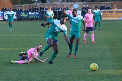 Leatherheads Shaun Okojie (green, L) skips away from the challenge of Sam Hatton