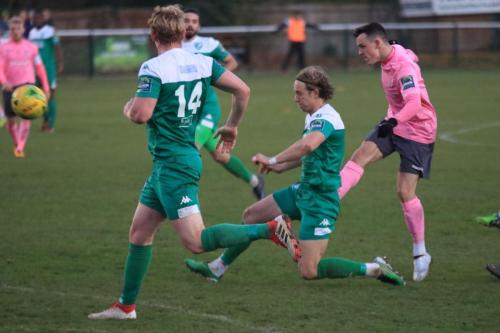 Leatherheads Will Salmon (green, R) deflects Brandon Adamss shot for a corner