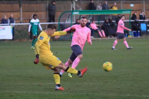 Leatherheads Zaki Oualah clears ahead of the onrushing Billy Bricknell