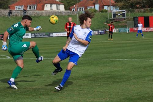 Enfields Sam Chaney (R) blocks a clearance from Lewis Carey but the ball runs to safety