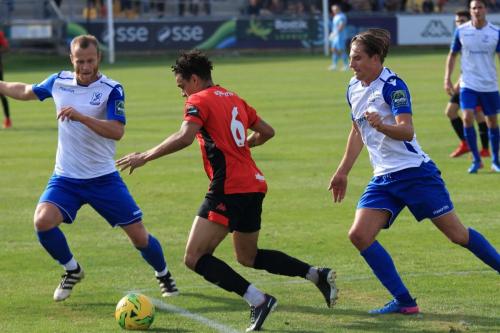 Enfields Sam Hatton (L) and Sam Youngs challenge Leon Redwood